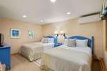 This charming bedroom features two comfortable beds with cozy bedding, perfect for a relaxing stay.