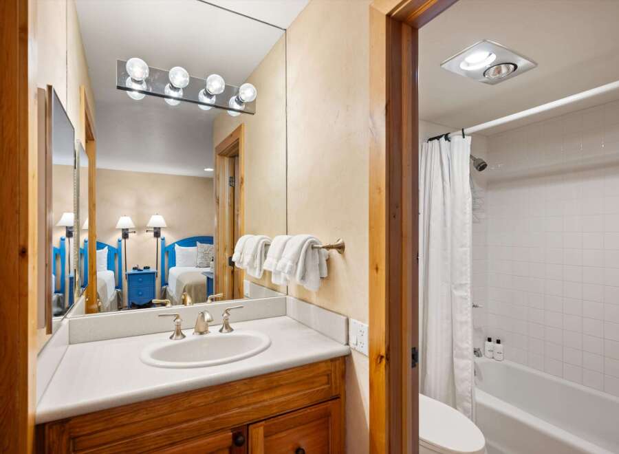 This inviting bathroom features a stylish vanity with a sleek countertop and a classic sink.