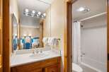 This inviting bathroom features a stylish vanity with a sleek countertop and a classic sink.
