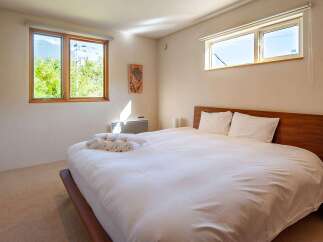 Experience tranquility in this inviting bedroom, featuring a comfortable bed and ample natural light.