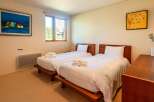 This cozy bedroom features two twin beds, perfect for guests or family members.
