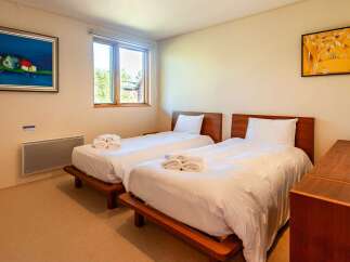This cozy bedroom features two twin beds, perfect for guests or family members.