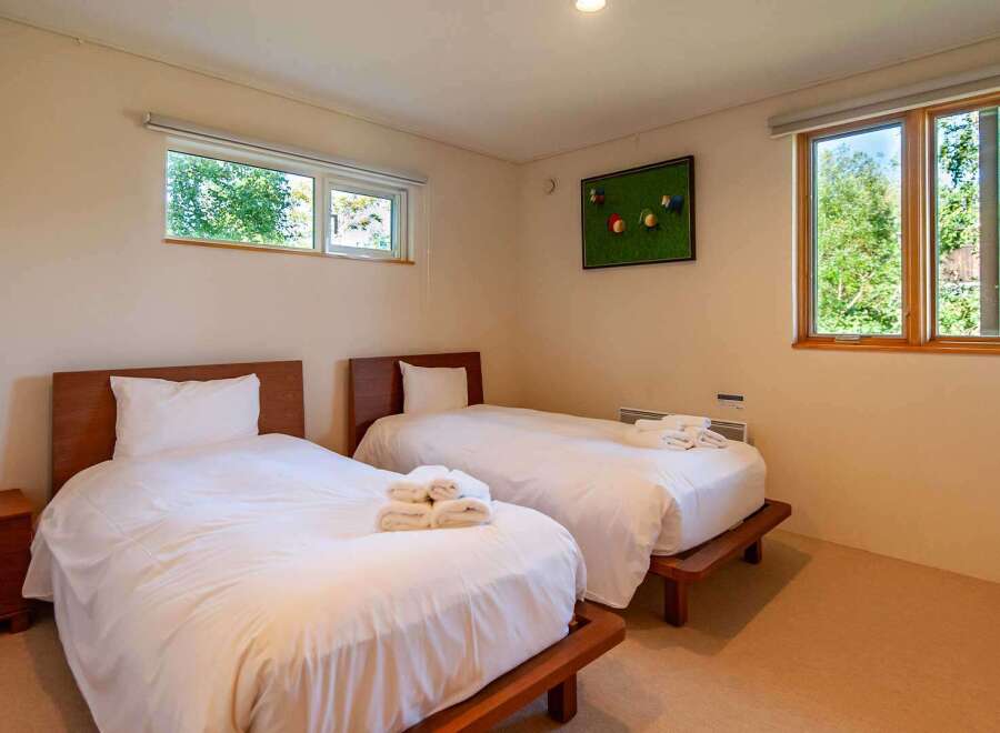 This cozy bedroom features two twin beds, perfect for guests or family members.