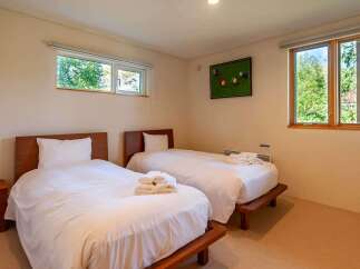 This cozy bedroom features two twin beds, perfect for guests or family members.