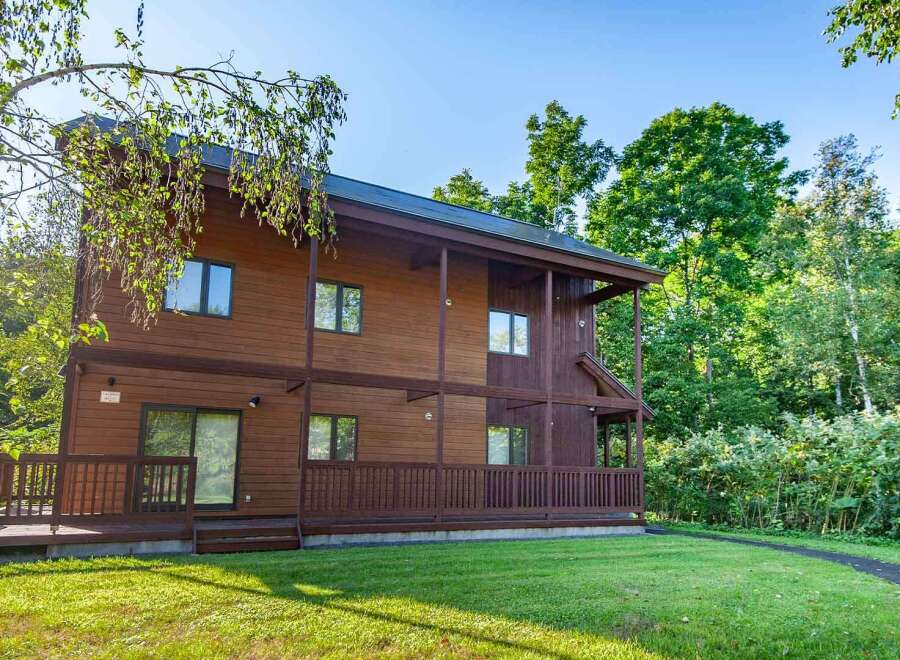 Discover the charm of this stunning wooden house nestled in a serene, tree-lined setting.