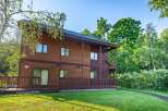Discover the charm of this stunning wooden house nestled in a serene, tree-lined setting.