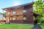 This stunning wooden house offers a blend of modern design and natural beauty.