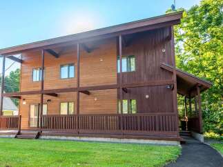 This stunning wooden house offers a blend of modern design and natural beauty.
