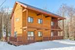 This stunning wooden house offers a warm and inviting atmosphere.