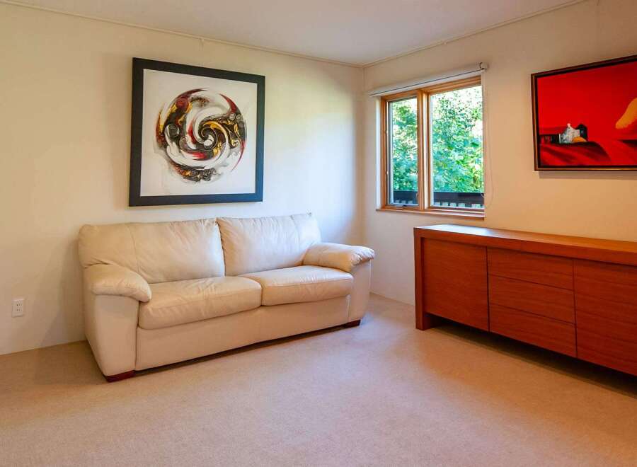 This inviting living space features a comfortable cream-colored sofa, perfect for relaxing.