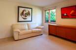 This inviting living space features a comfortable cream-colored sofa, perfect for relaxing.
