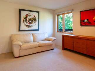 This inviting living space features a comfortable cream-colored sofa, perfect for relaxing.