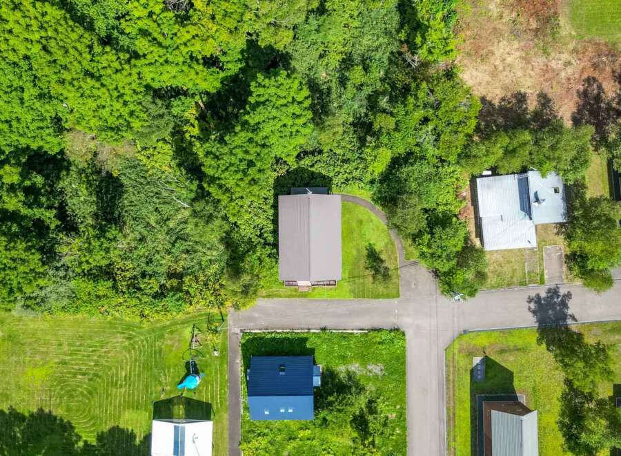 Discover a charming property nestled in a serene, tree-filled setting.