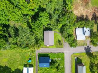 Discover a charming property nestled in a serene, tree-filled setting.