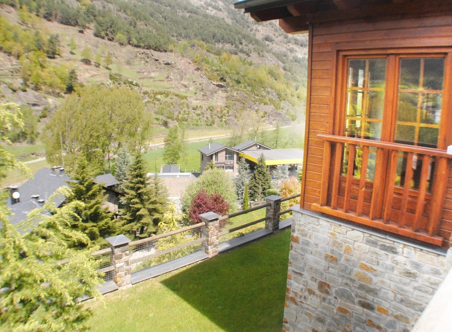 Mountain view home with a spacious balcony and large windows.