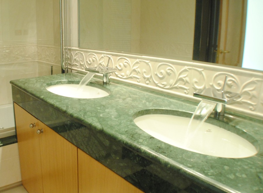 Indulge in luxury with this stunning bathroom featuring dual sinks and a sleek, modern design.
