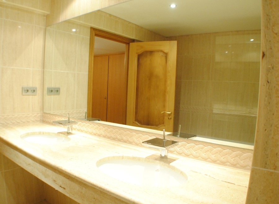 Luxury bathroom with double sinks and marble countertops.