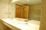 Luxury bathroom with double sinks and marble countertops.
