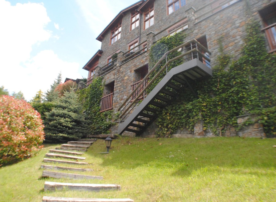 This stunning stone building boasts a charming exterior with lush greenery.
