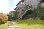 This stunning stone building boasts a charming exterior with lush greenery.