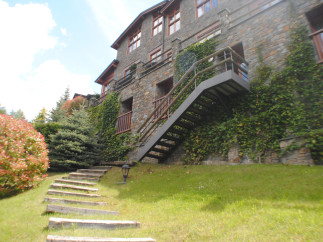 This stunning stone building boasts a charming exterior with lush greenery.