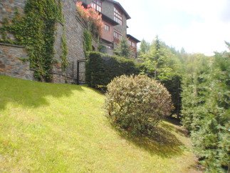 Nestled in a lush green landscape, this stone house offers stunning views and a tranquil atmosphere.