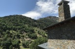 Mountain view home with stone exterior and a large chimney.