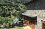Mountain view home with stone exterior and wooden accents.