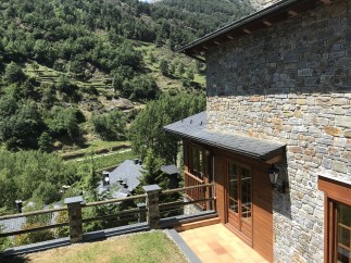 Mountain view home with stone exterior and wooden accents.