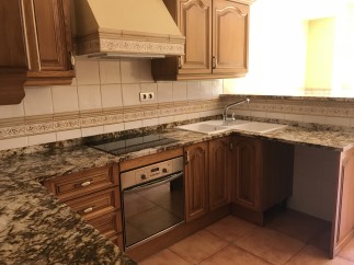 This stunning kitchen boasts beautiful wood cabinets and granite countertops, creating a luxurious feel.