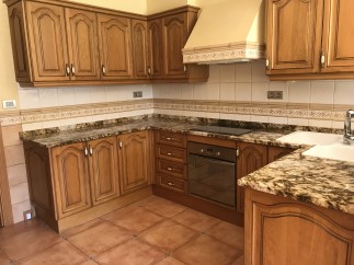 This beautiful kitchen boasts granite countertops and custom wooden cabinetry, creating a warm and inviting atmosphere.