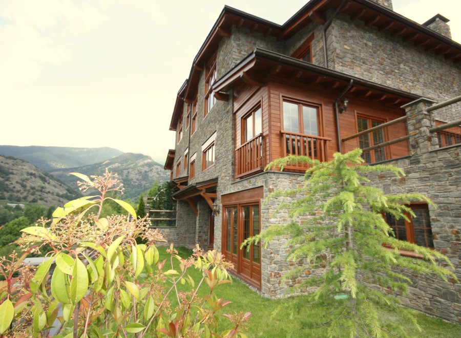 Mountainside luxury home with stone exterior and wood accents.