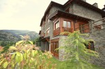 Mountainside luxury home with stone exterior and wood accents.