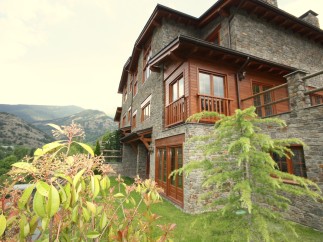 Mountainside luxury home with stone exterior and wood accents.