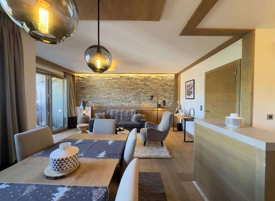 Experience luxury living in this stunning property, featuring a beautifully designed living room with a cozy sofa and a stylish armchair.