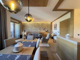 Experience luxury living in this stunning property, featuring a beautifully designed living room with a cozy sofa and a stylish armchair.