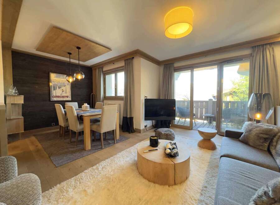 Experience luxury living in this stunning property, featuring a spacious living area with a cozy fireplace and a modern kitchen.