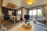 Experience luxury living in this stunning property, featuring a spacious living area with a cozy fireplace and a modern kitchen.
