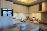 This modern kitchen boasts sleek cabinetry and stainless steel appliances, creating a stylish and functional space.