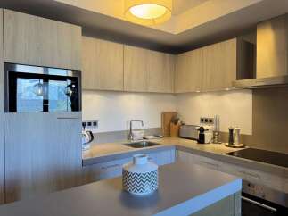 This modern kitchen boasts sleek cabinetry and stainless steel appliances, creating a stylish and functional space.