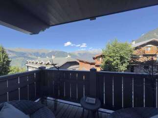 Enjoy breathtaking mountain views from this charming balcony.