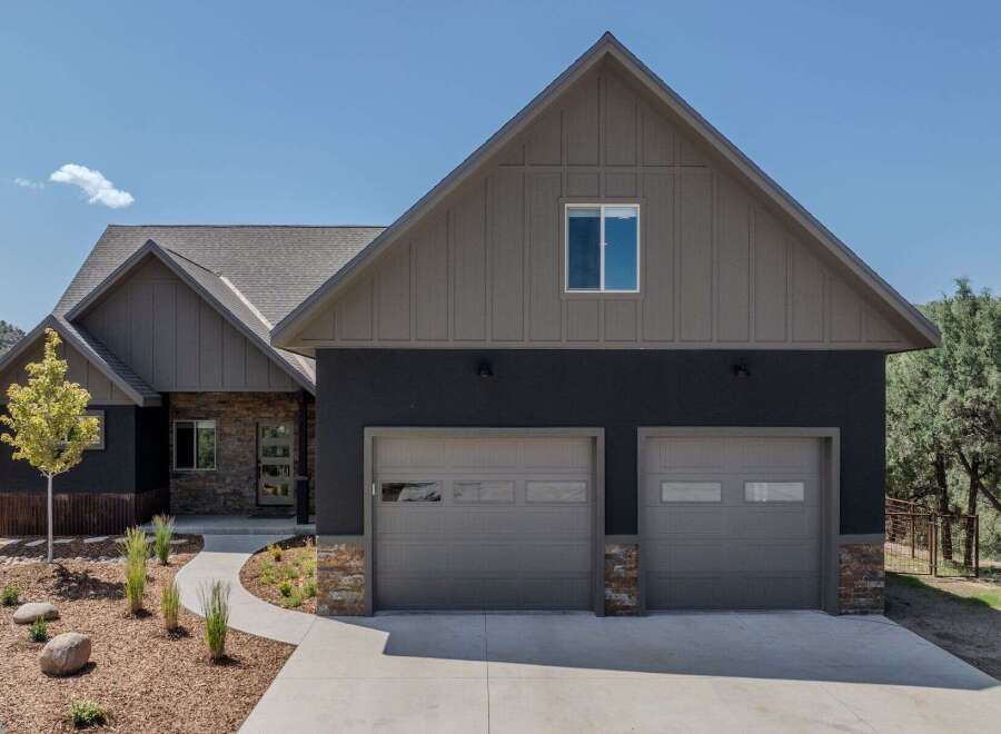 This stunning property boasts a modern design with a focus on curb appeal.