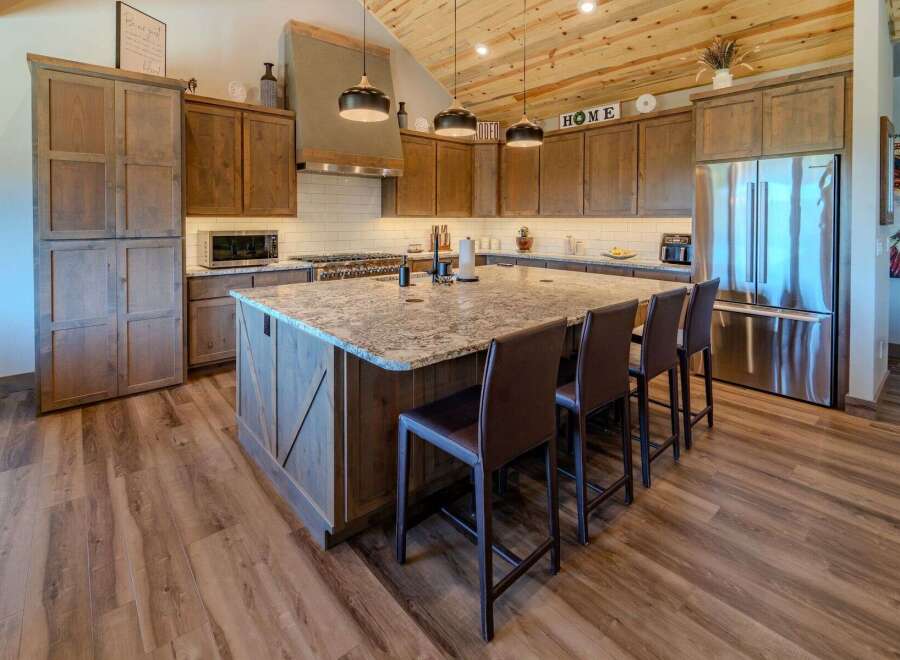 This stunning kitchen boasts a spacious island with seating, perfect for entertaining or casual dining.