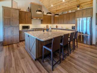 This stunning kitchen boasts a spacious island with seating, perfect for entertaining or casual dining.