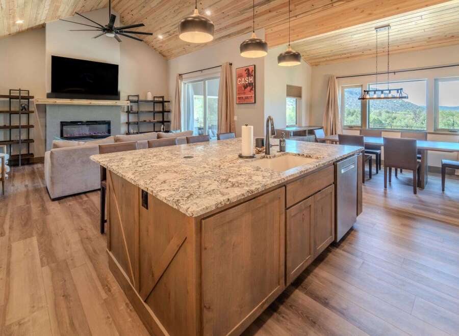 Experience luxury living in this stunning property featuring a spacious kitchen island with granite countertops, perfect for culinary creations and entertaining.