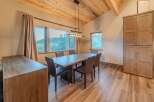 This stunning dining room features a beautiful wooden table and chairs, perfect for hosting dinner parties or enjoying family meals.