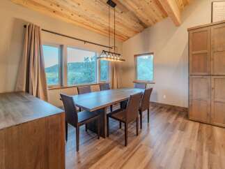 This stunning dining room features a beautiful wooden table and chairs, perfect for hosting dinner parties or enjoying family meals.