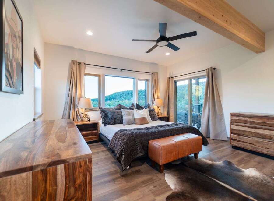 This luxurious bedroom boasts a stunning view and ample natural light, creating a serene retreat.