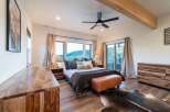 This luxurious bedroom boasts a stunning view and ample natural light, creating a serene retreat.