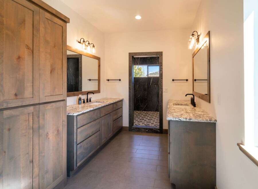 Step into luxury with this stunning bathroom featuring dual vanities and a spacious design.